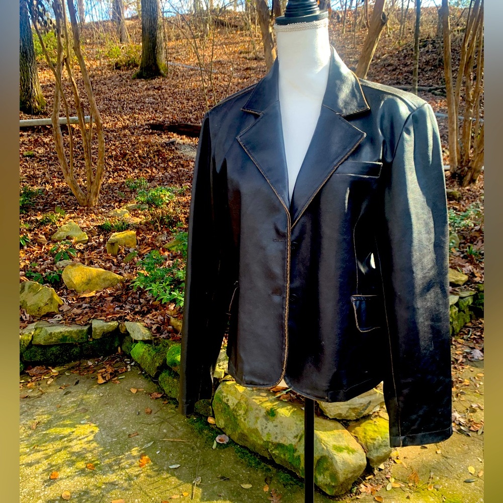 Leather look soft brown jacket with details.